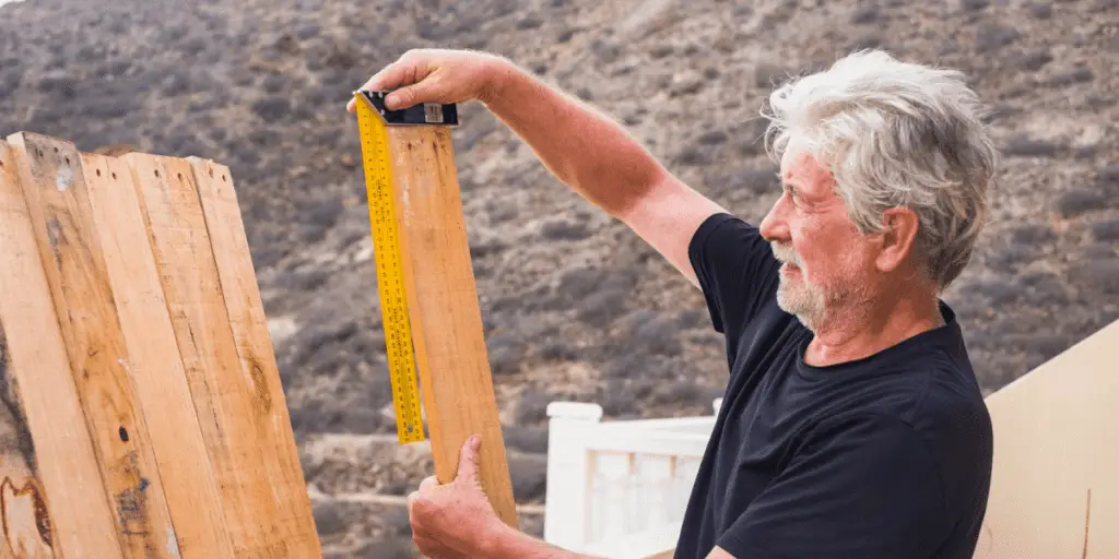 Retired man working on DIY project outside